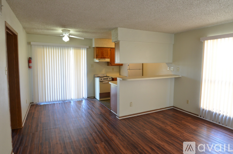 A room with wooden floors and white walls.