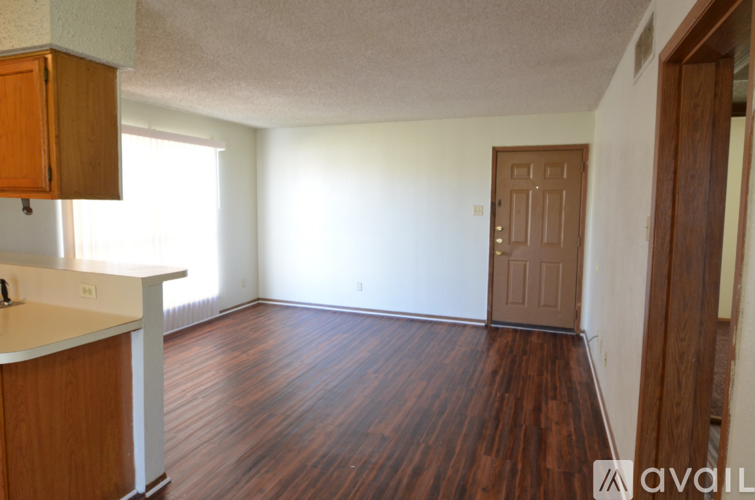 A room with wooden floors and a white countertop.