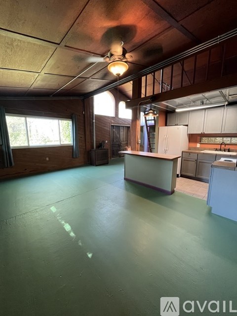 A large open space with a counter and cabinets.
