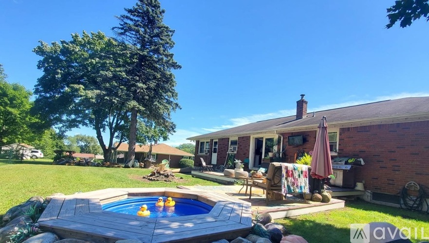 A backyard with a pool table and a hot tub.