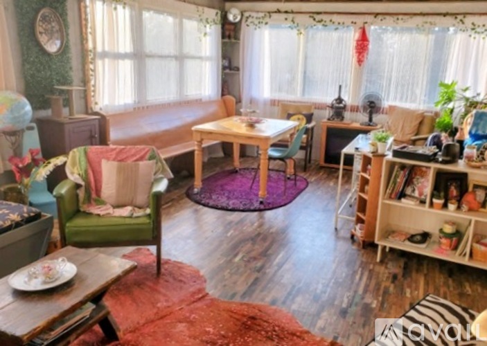 A living room with a couch, chairs, and a coffee table.