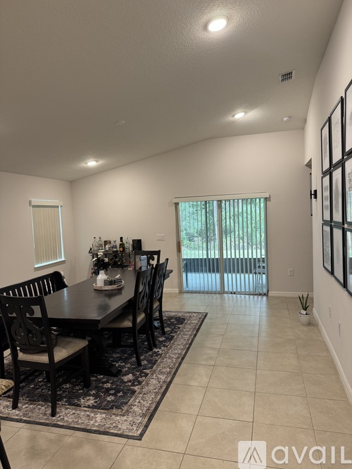 A dining room with a table set for six.
