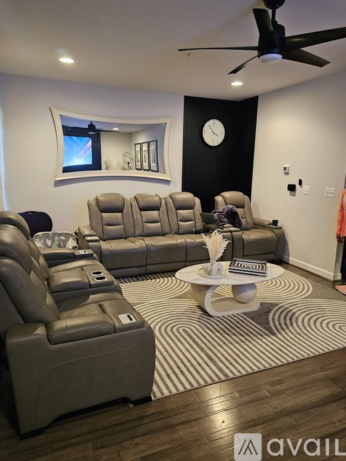 A living room with a striped rug and two recliners.