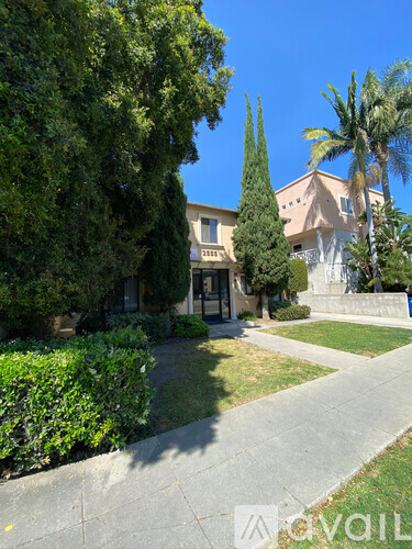 A house with a white fence and a green lawn.