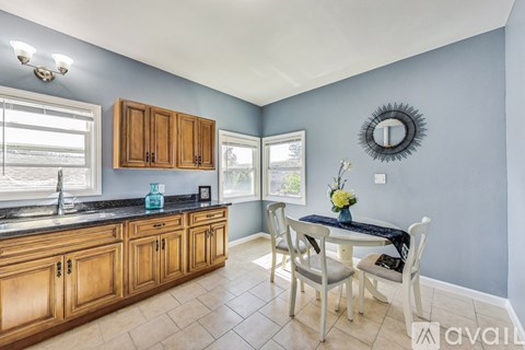 A kitchen with wooden cabinets and a black countertop.