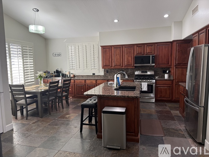A kitchen with a table and chairs.