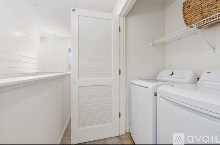 A white laundry room with a washer and dryer.