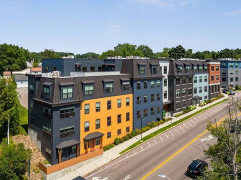 A row of modern townhouses with different colored exteriors.