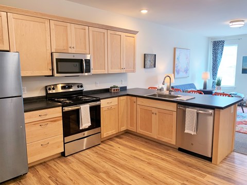 A kitchen with wooden cabinets and stainless steel appliances.
