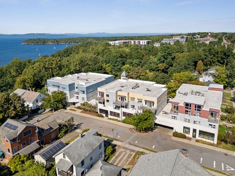A view of a town with a large building in the middle.