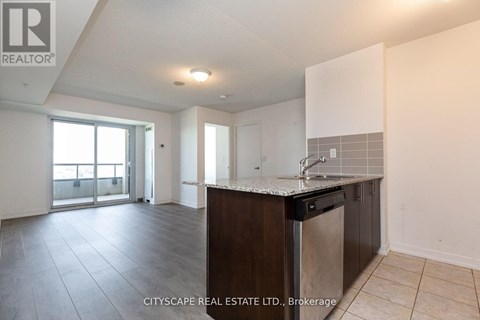 A kitchen area with a sink and a countertop.