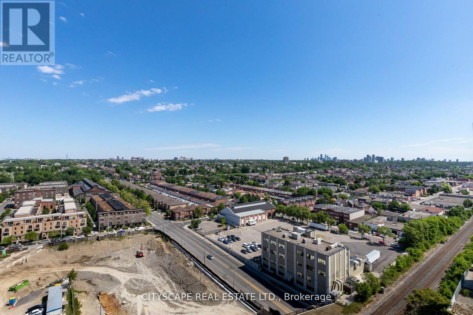 An aerial view of a cityscape with buildings and a construction site.
