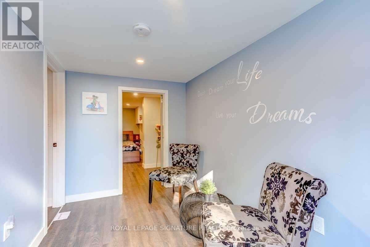 A living room with a couch and a wall decal that says "Life Dreams".