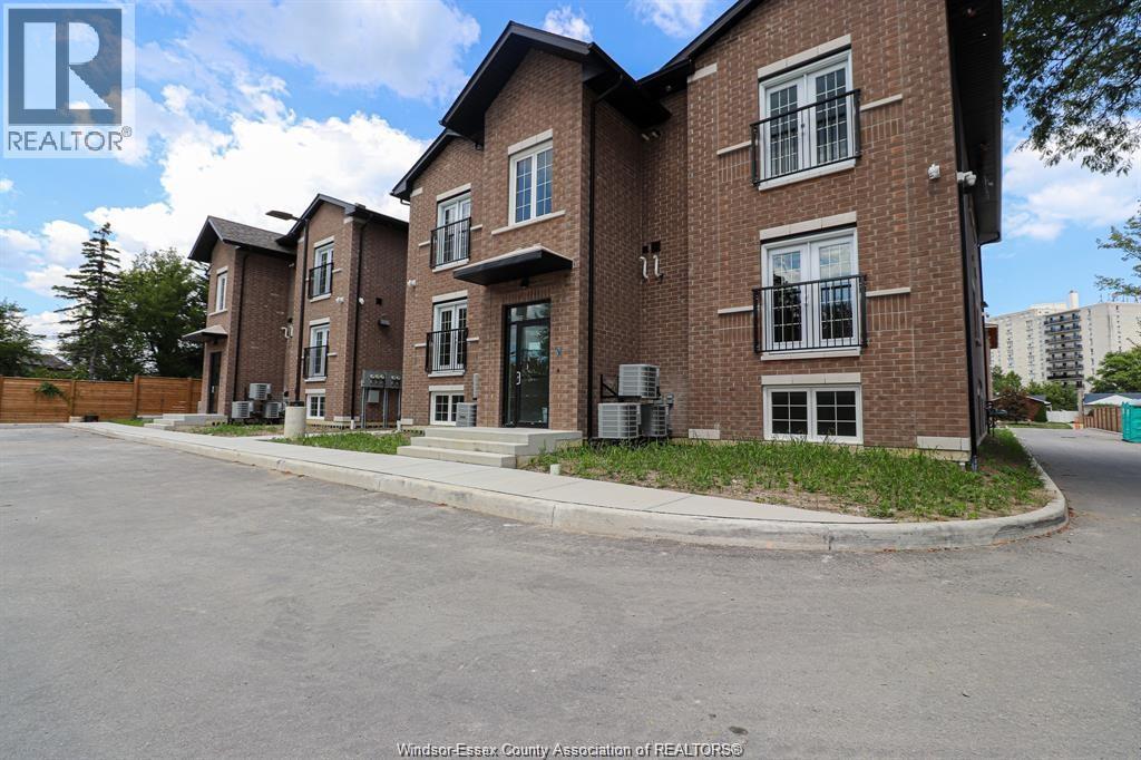 A large brick building with a parking lot in front.