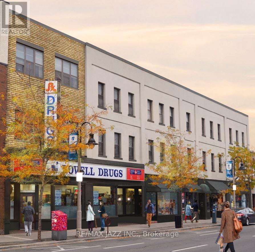 A street view of a city with a white building and a red and white sign that says "Dowell Drugs".