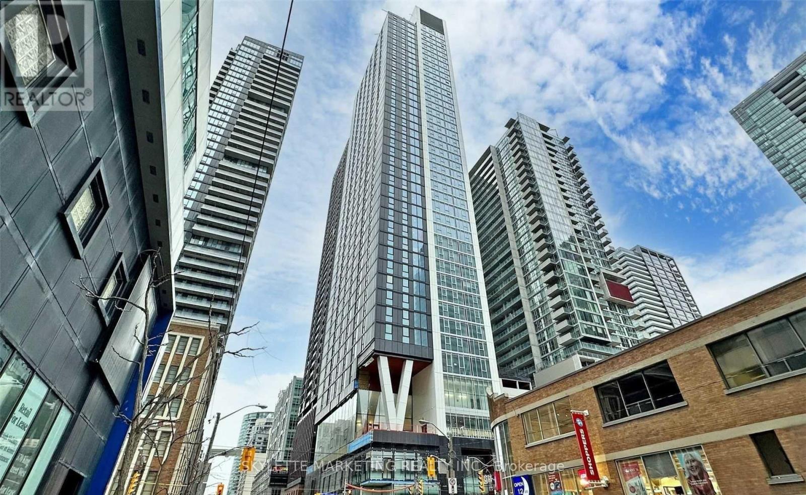 A cityscape with tall buildings and a clear sky.