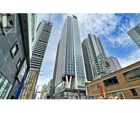 A cityscape with tall buildings and a clear sky.