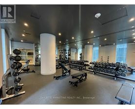 A gym with a variety of equipment including weights and benches.