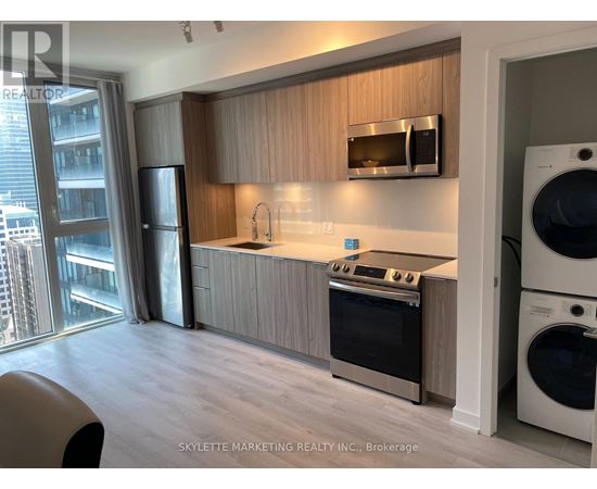A modern kitchen with wooden cabinets and stainless steel appliances.