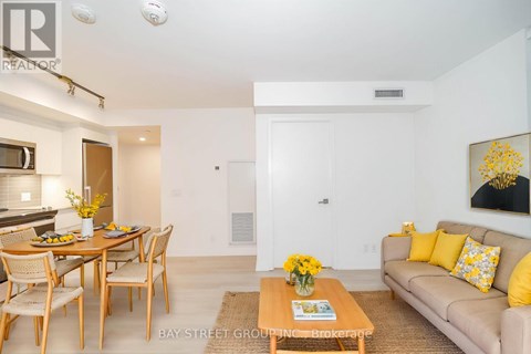A living room with a dining table and a couch.