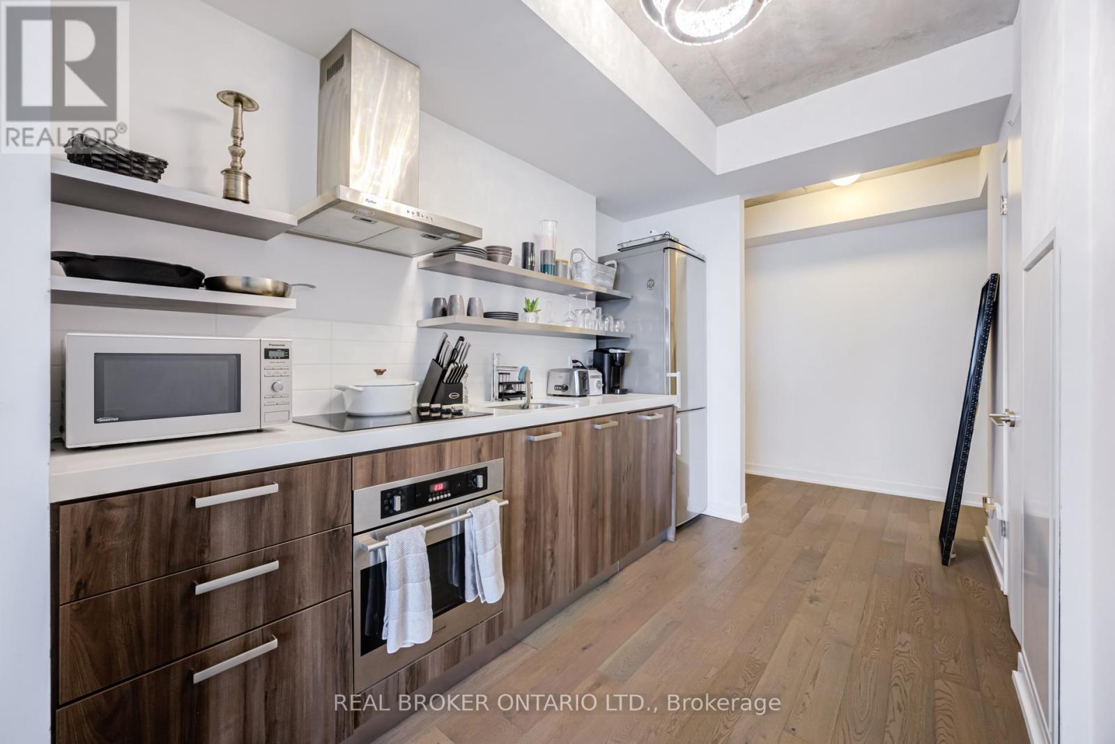 A kitchen with wooden cabinets and a white counter top.