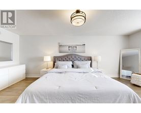 A bedroom with a large bed and a chandelier.