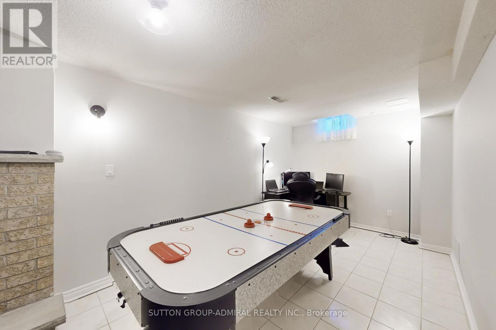 A room with a pool table and a chair.