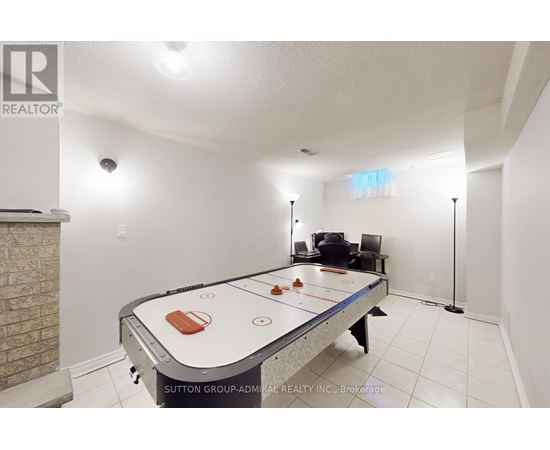 A room with a pool table and a chair.