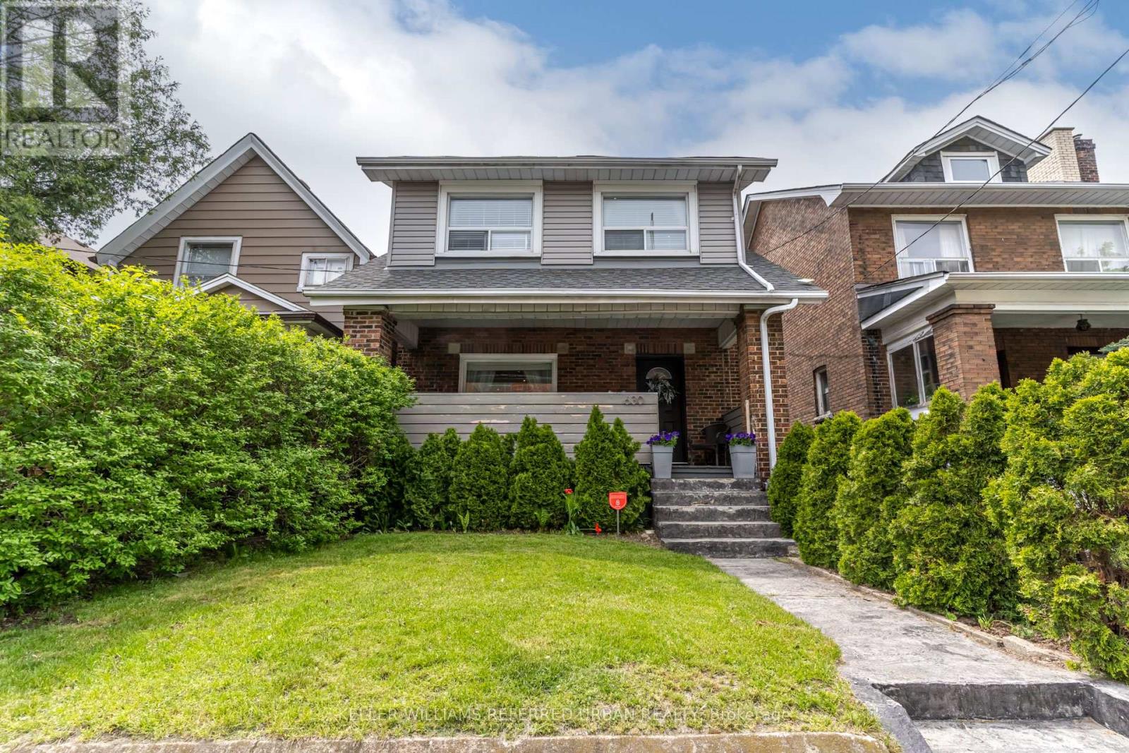 A house with a well-maintained lawn and a clear sky.