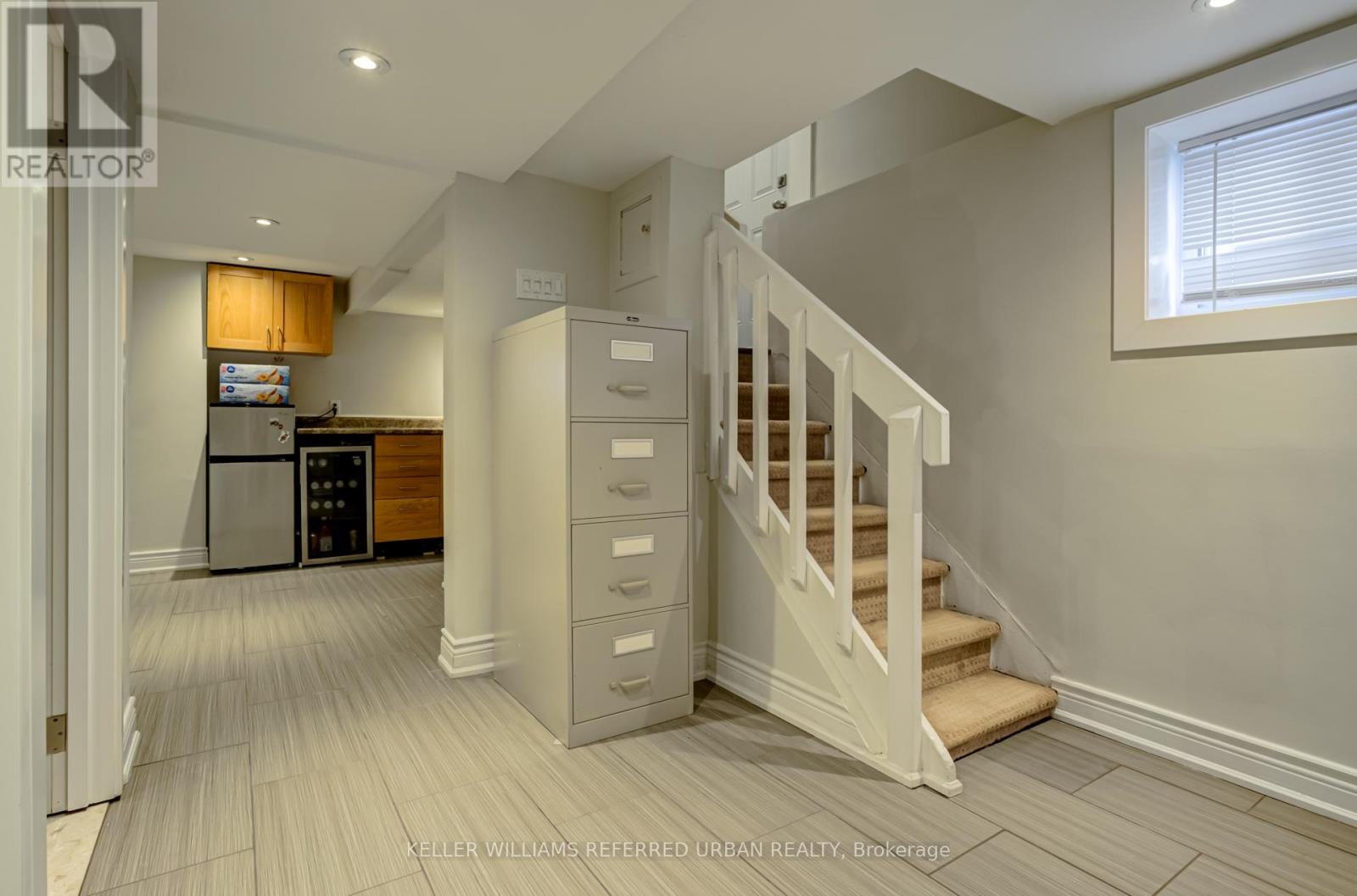 A spacious hallway with a staircase leading to the upper floor.
