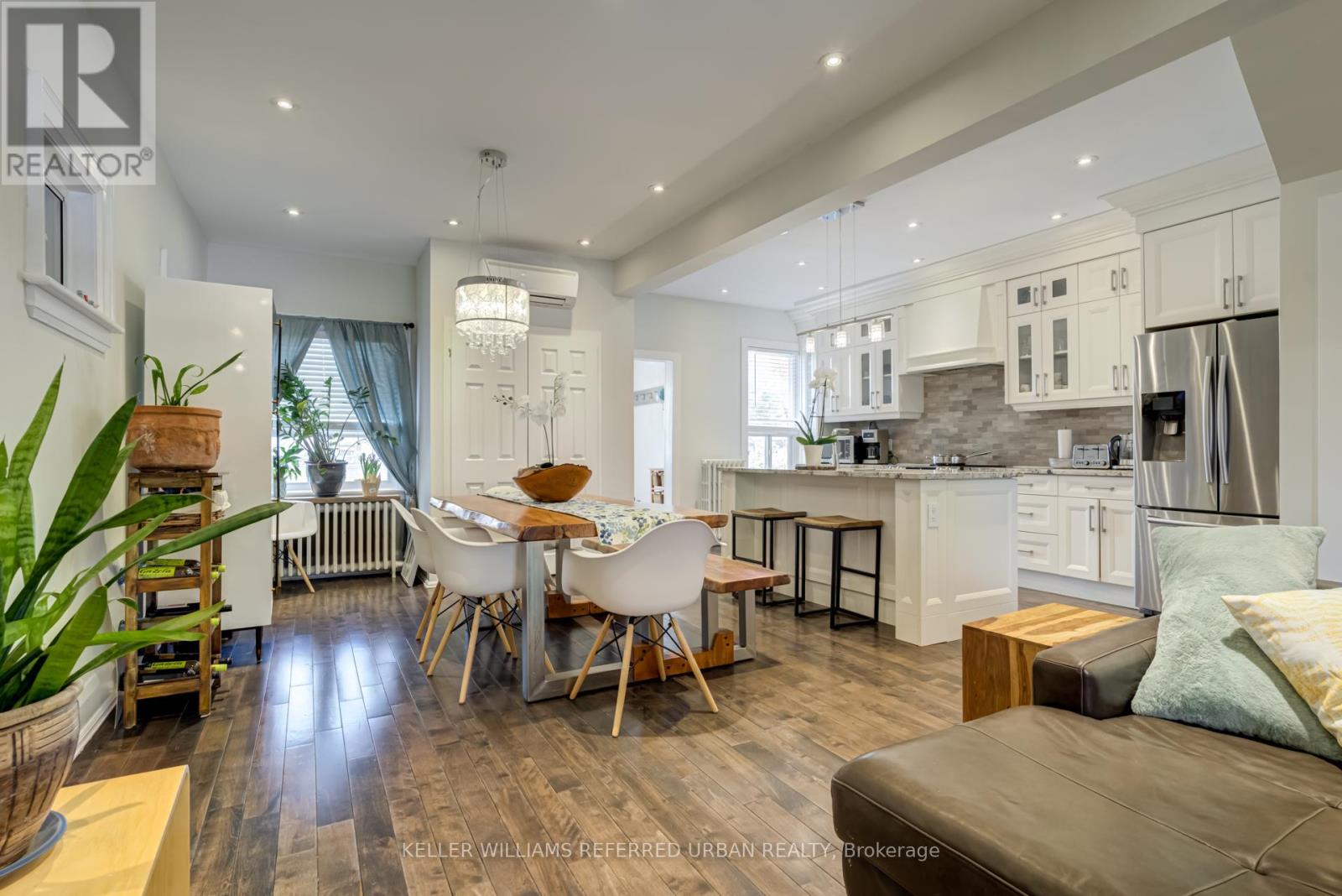 A modern kitchen with a dining table and chairs.