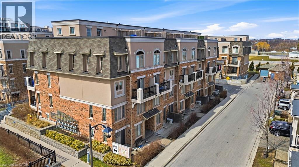 A row of apartment buildings with a street in front.