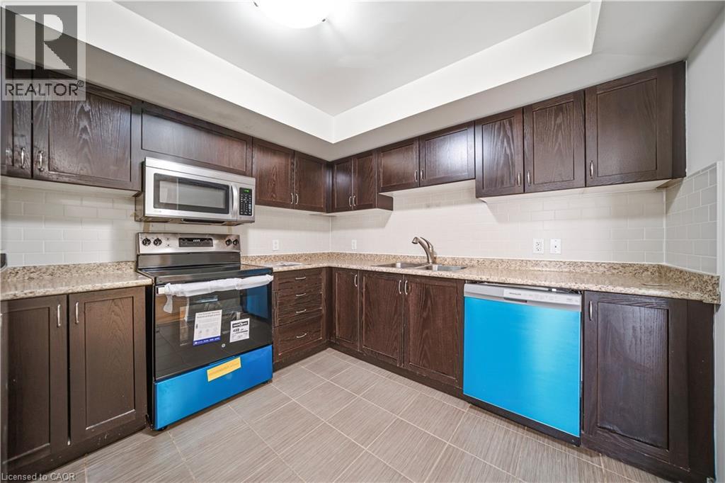 A kitchen with brown cabinets and a blue dishwasher.
