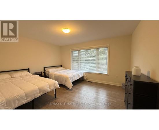 A bedroom with two beds and a dresser.