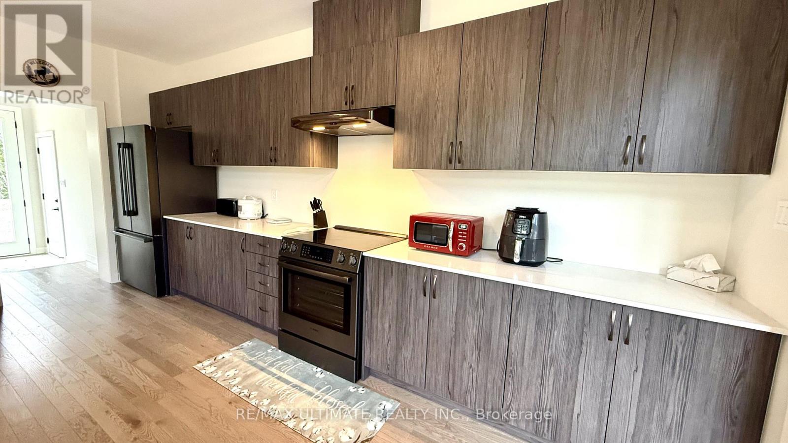 A kitchen with wooden cabinets and a stainless steel oven.