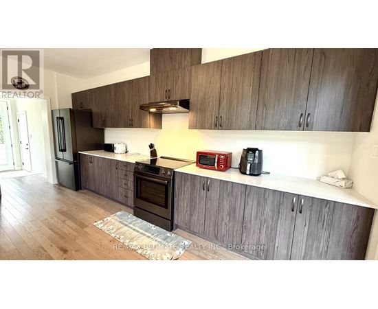 A kitchen with wooden cabinets and a stainless steel oven.