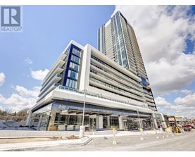 A modern multi-story building with a glass facade is under construction.