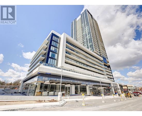 A modern multi-story building with a glass facade is under construction.