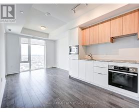 A kitchen with white cabinets and a black oven.
