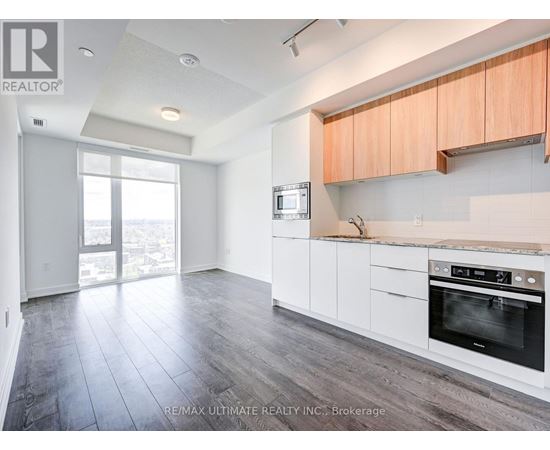 A kitchen with white cabinets and a black oven.