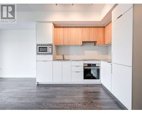 A kitchen with white cabinets and a microwave above the oven.