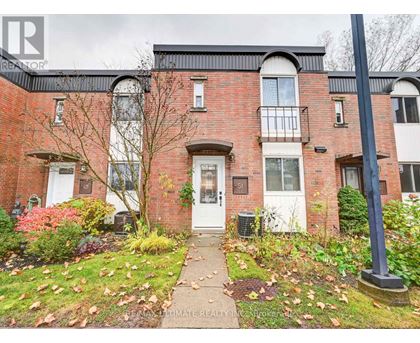 A red brick house with a white door and windows.