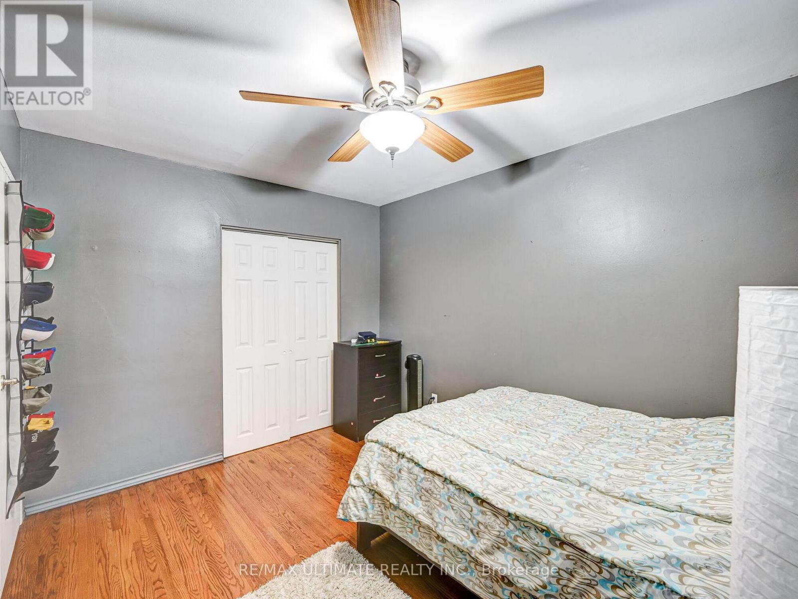 A bedroom with a bed, dresser, and closet.