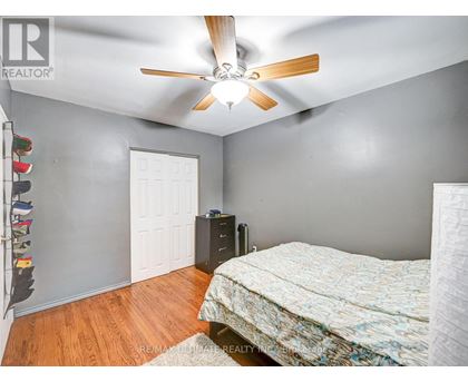 A bedroom with a bed, dresser, and closet.
