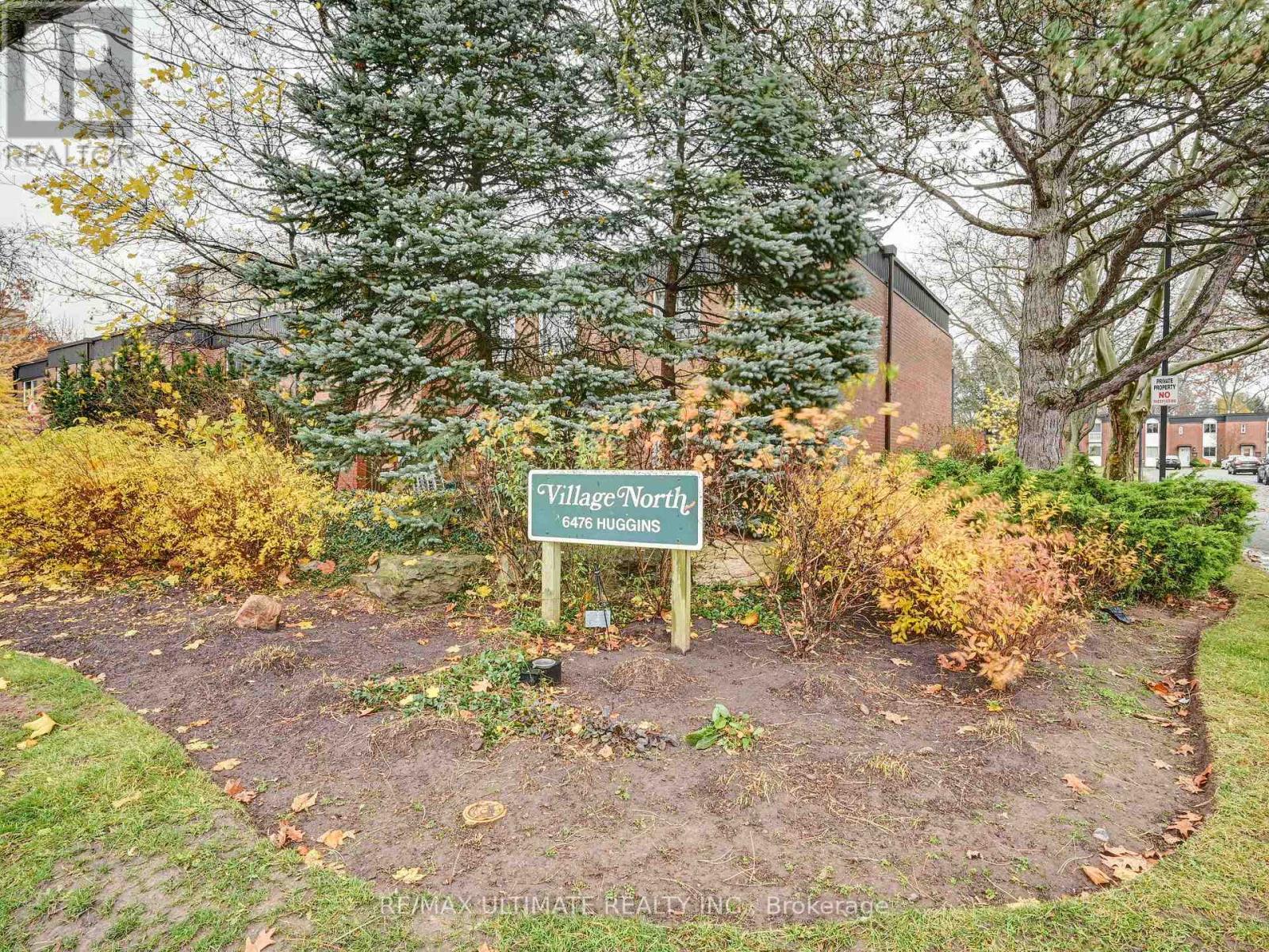 A sign in a garden that says Village Worthy.