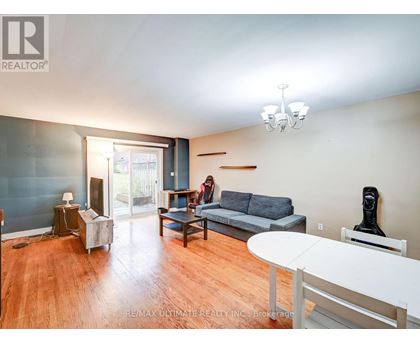 A living room with a grey couch and a white table.