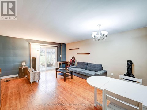 A living room with a grey couch and a white table.