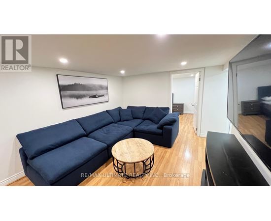 A living room with a blue sectional sofa and a wooden coffee table.