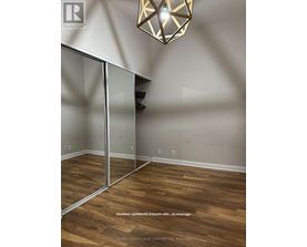A room with wooden floors and a glass partition wall.