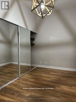 A room with wooden floors and a glass partition wall.